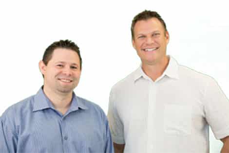 Mike & Mike posing for a photo in front of a white background.