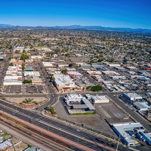 Aerial view of a Glendale, Arizona suburban area with buildings and roads on a clear day.